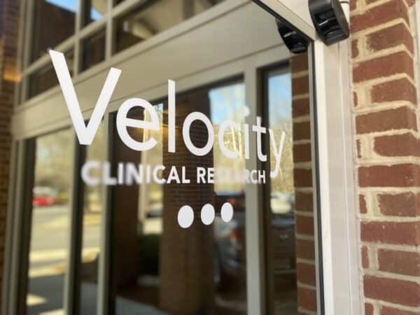 velocity clinical research logo on door